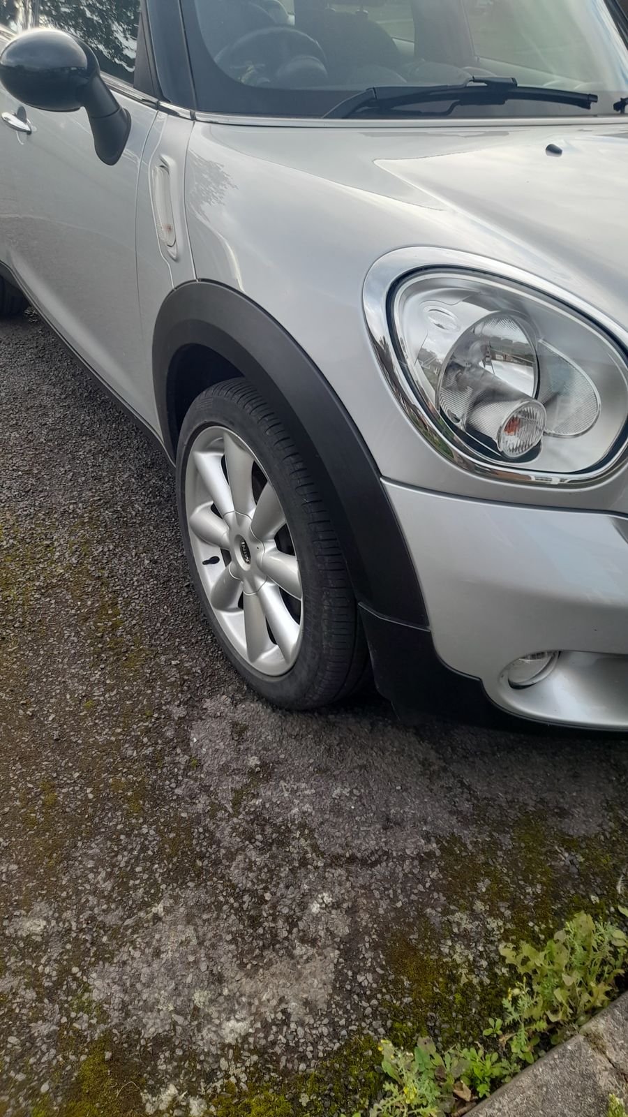 The front wheel and tyre of a silver Mini